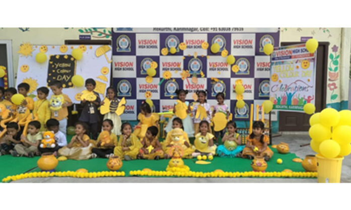 Students at Vision High School in Rekurthi celebrating Yellow Color Day with yellow dresses and toys