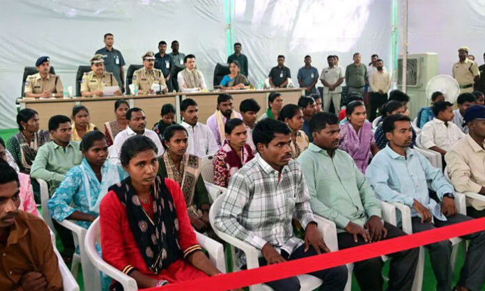 Maoists surrendering before Telangana DGP Shivadhar Reddy and handing over weapons