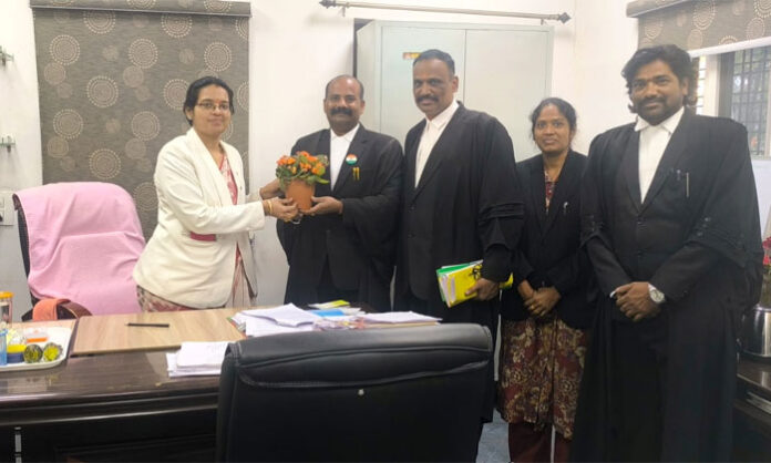 Suraksha Seva Sangham members meeting Rangareddy District Legal Services Authority Secretary G. Anusha at court complex