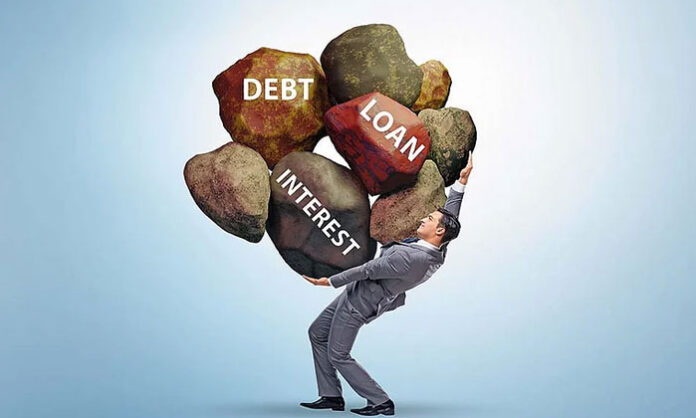 Image showing a stressed middle-class man calculating EMIs, loans, and household expenses.