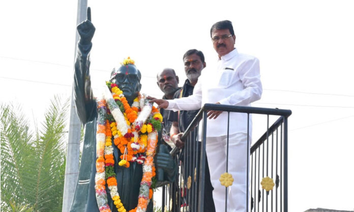 Former Minister Niranjan Reddy paying tributes to Dr. B.R. Ambedkar by garlanding his statue at Ambedkar Chowk on the death anniversary.