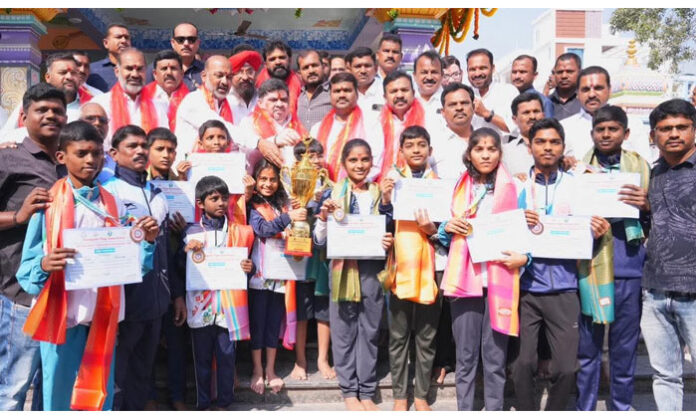 Telangana state-level yoga medal winners being congratulated by Union Minister Bandi Sanjay and Minister Ponnam Prabhakar in Karimnagar.