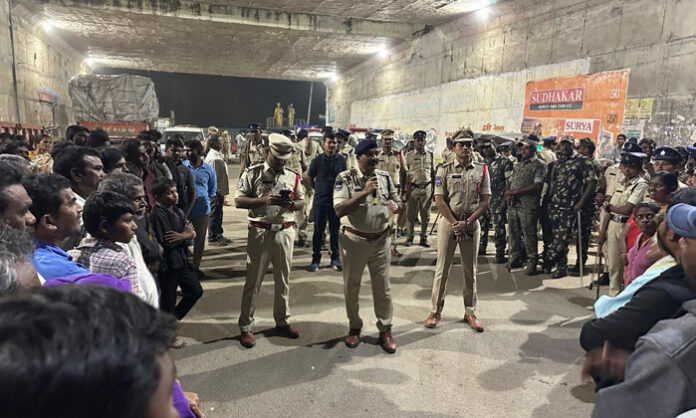 Suryapet DSP Prasanna Kumar leading a flag march in Chandupatla village to promote peaceful and fair elections in Chivvemla Mandal.