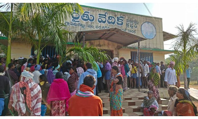 Farmers waiting in long queues at Enugallu Rythu Vedika in Warangal district due to urea shortage.