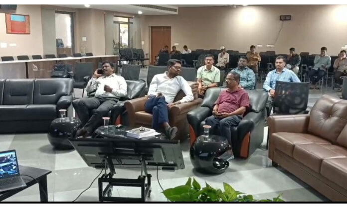 Image showing Wanaparthy District Collector Adarsh Surabhi monitoring the first phase of Gram Panchayat polling through webcasting in the collectorate meeting hall.