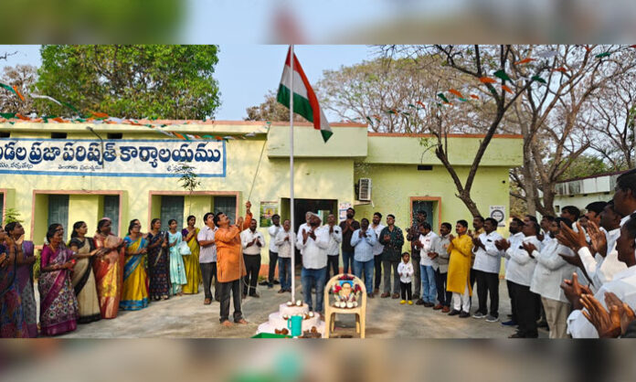 National flag hoisting during 77th Republic Day celebrations at Parvathagiri mandal with officials and villagers participating