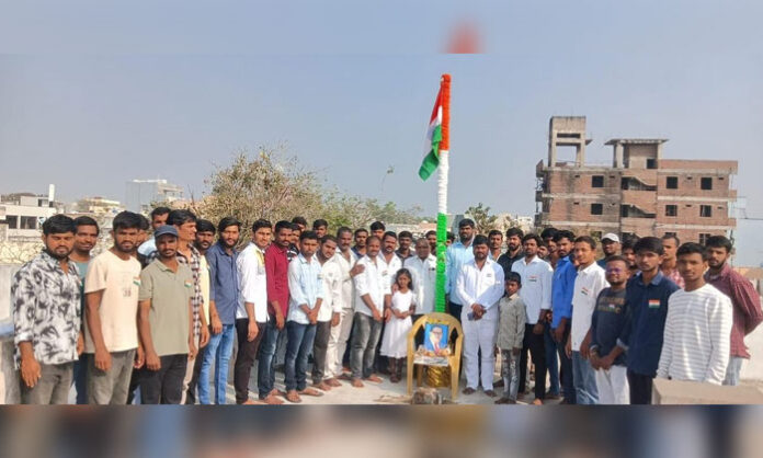 BRS Youth President Alakunta Hari hoists the national flag during 77th Republic Day celebrations in Tarnaka division slums, Hyderabad