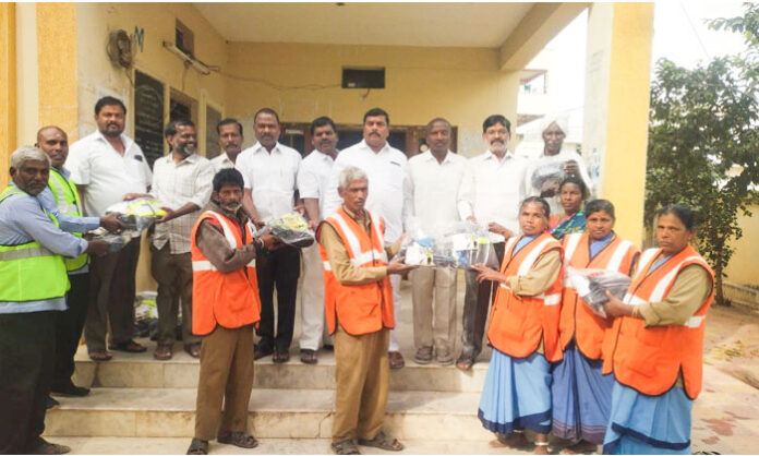 Sanitation workers in Pudur receiving safety equipment from Shubham Safety Company.