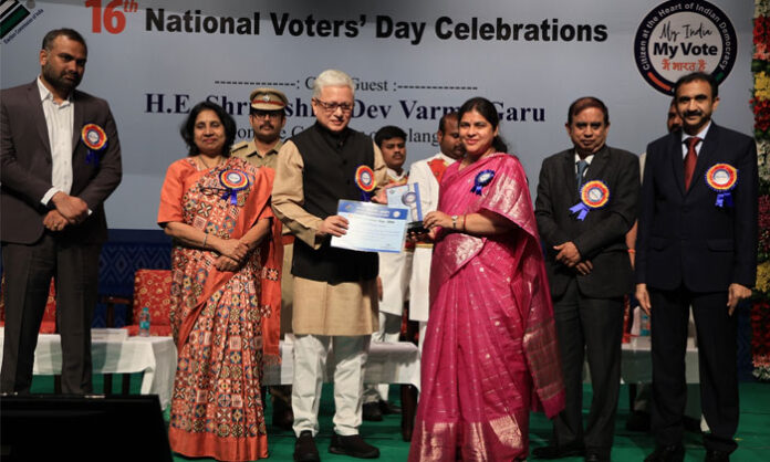 Governor Jishnu Dev Varma presenting National Voters Day award to Warangal District Collector Dr Satya Sarada Devi at Ravindra Bharathi