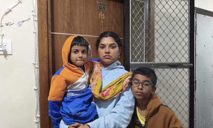 Wife stages protest outside husband’s house demanding justice after he lives with another woman.