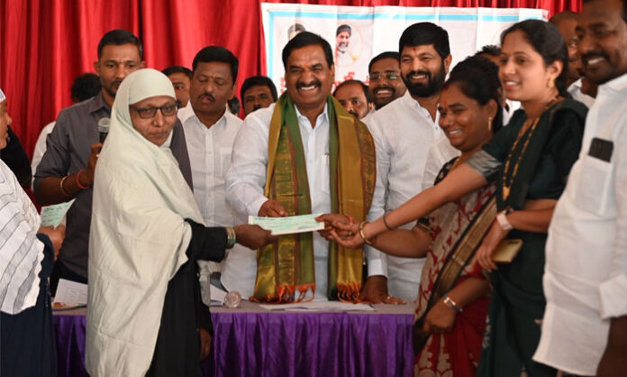 Ibrahimpatnam MLA MalReddy Rangareddy distributing Kalyana Lakshmi and Shaadi Mubarak cheques to beneficiaries at Shiva Gardens in Abdullapurmet mandal