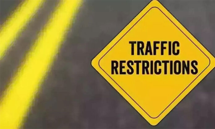 Traffic diversion signboards and police personnel managing vehicle movement near Sri Ramalingeswara Swamy Temple in Keesaragutta during Shivaratri festival