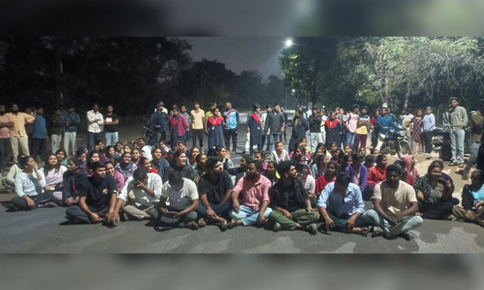 Osmania University students holding placards and protesting in front of Arts College over hostel issue