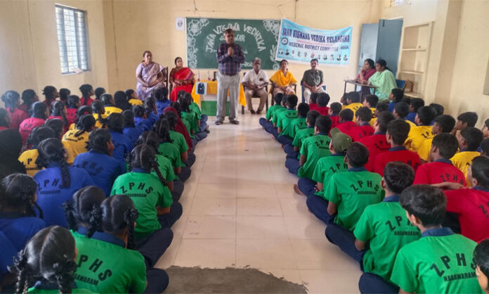 Dr Ramachandraiah explaining the periodic table as the foundation of chemistry at a Jana Vignana Vedika science awareness program
