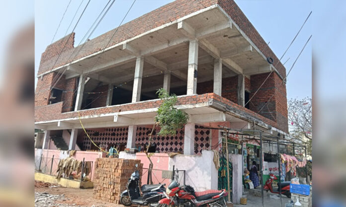 Locals protesting illegal building construction encroaching road in Jawahar Nagar Hyderabad