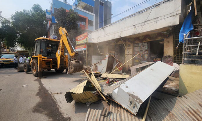 Encroachment removal drive by municipal officials in Gundla Pochampally clearing roadside structures
