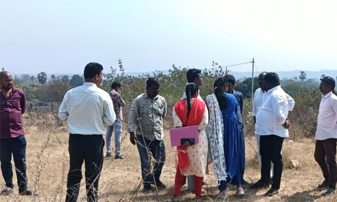 Government officials and village representatives inspecting Survey No 128 land in Surmaiguda for cemetery allocation