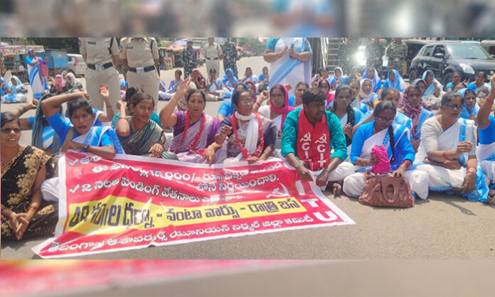 Asha workers staging protest and road blockade near RDO office in Nirmal demanding ₹18000 salary and resolution of issues