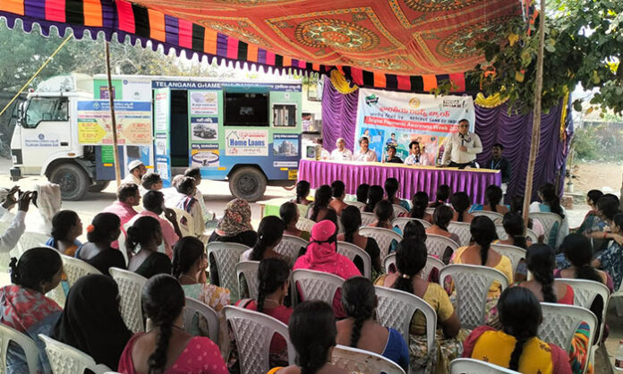 Bank officials conducting cyber crime awareness program with a mobile vehicle in Beervelli village of Sarangapur mandal.