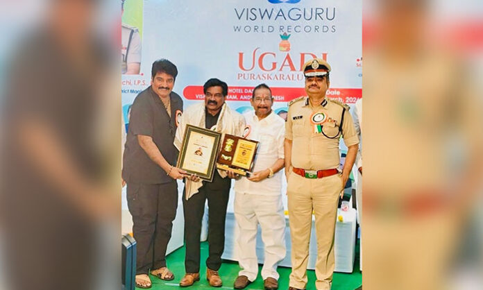 Dr Perumalla Pradeep Kumar receiving felicitation after winning silver medal at World Powerlifting Championship during Ugadi Awards event in Visakhapatnam.