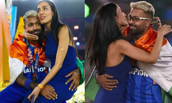 Hardik Pandya celebrating India’s T20 World Cup 2026 victory while draping national flag over shoulders with girlfriend Mahika Sharma