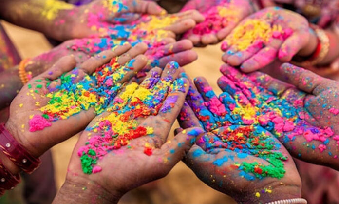People celebrating Holi festival with vibrant colors symbolizing joy, unity, and the arrival of spring
