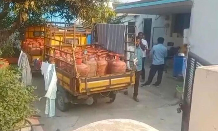 Officials seizing 54 illegally stockpiled gas cylinders from Santosh HP Gas Agency dealer’s residence in Nirmal