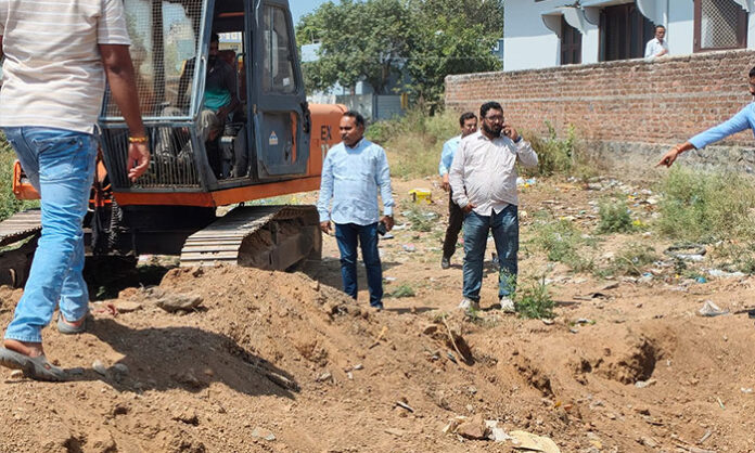 Revenue and irrigation officials removing illegal encroachments on Kancharoni Lake Shikham lands in Nirmal Town to protect public property and water bodies