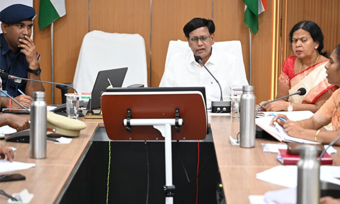 Officials attending a meeting at the Nirmal Collectorate to discuss NDRF disaster awareness programs for the public.