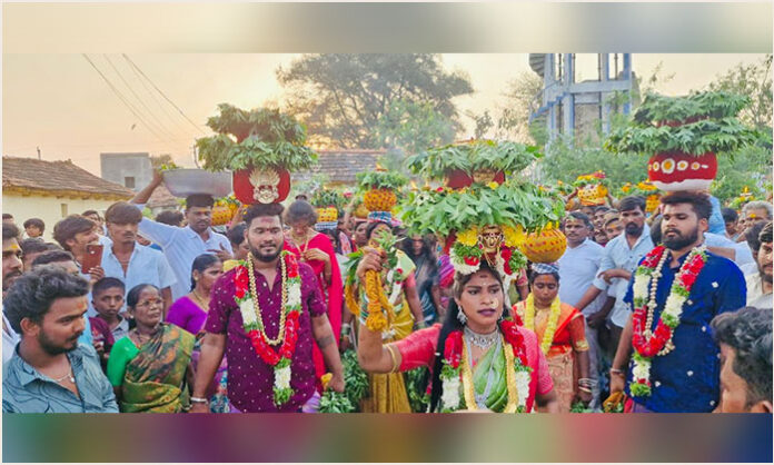 Devotees carrying Bonalu offerings during Nalla Pochamma Jatara celebration in Jaggampeta village.