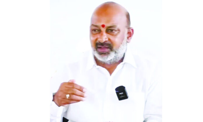 Farmers protesting for completion of Ranganayak Sagar canal work in Rajanna Sircilla district, with Union Minister Bandi Sanjay addressing media.