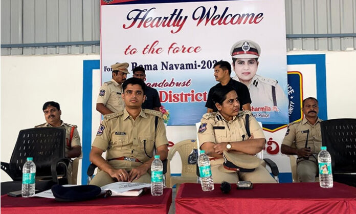 Police personnel deployed for security during the Sri Rama Navami Shobhayatra in Nirmal and Bhainsa, with surveillance via drones and videography to ensure public safety.