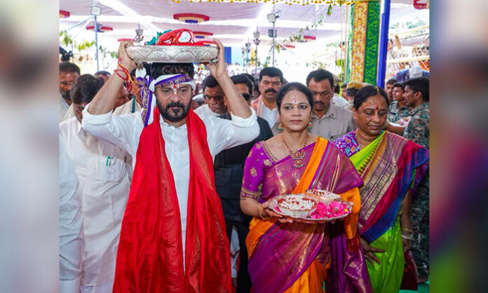 Chief Minister Revanth Reddy offering silk robes and pearl talambralu to Lord Sri Seetha Ramachandra Swamy during Thirukalyanam at Bhadrachalam, alongside ministers, MPs, MLAs, and thousands of devotees.