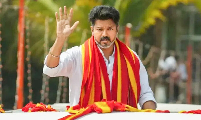 TVK Chief Vijay addressing a public meeting amid controversy over election code violation case registered by police.