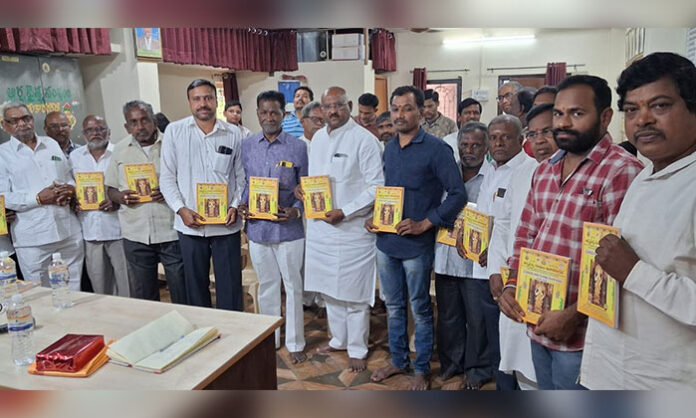 Uppala Rajeshwar Rao unveiling the new Panchangam at Tukarampet Arya Vysya Sangham Ugadi celebrations, with Sangham President Mallavolu Srikanth Madhav and General Secretary Nagabandi Srinivas
