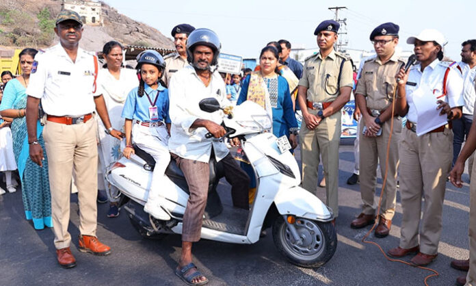 Collector Dr Satya Sarada leads Arrive Alive road safety awareness program with students forming human chain in Warangal