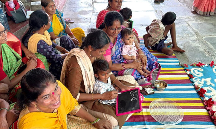 Anganwadi center program in Bellampalli with Aksharabyasam, Annaprasana ceremony and children clothing distribution