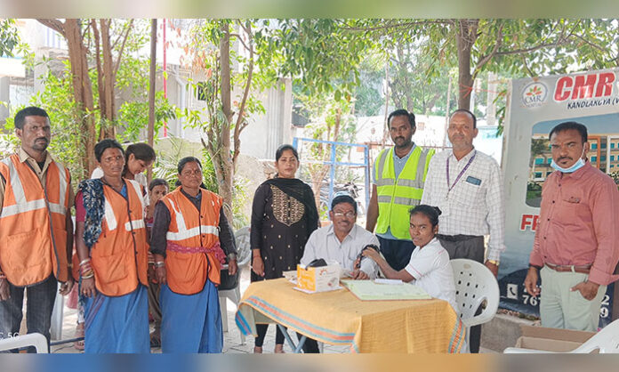 Doctors from CMR Hospital conducting free medical check-ups for local residents at Medchal GHMC office, distributing medicines and offering health advice.