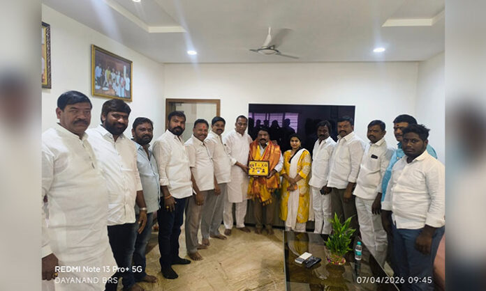 Gaddam Raj Kumar paying respects to MLA Malla Reddy after receiving the Dalit Ratna award