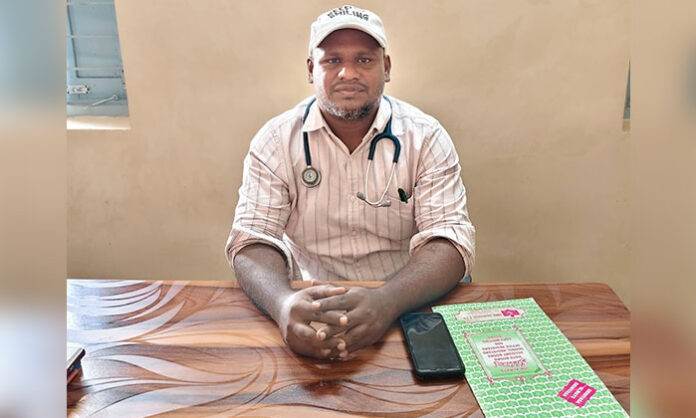 Medical Officer Naresh explaining heatstroke symptoms and prevention tips at Garidepalli Primary Health Centre
