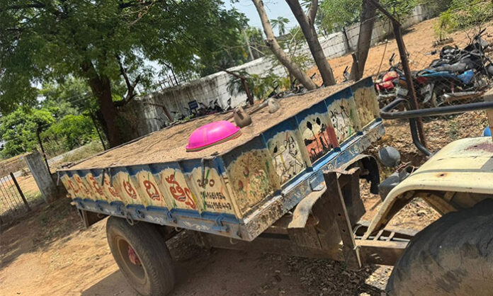 Police seizing a tractor involved in illegal sand transport in Jam village, Sarangapur Mandal