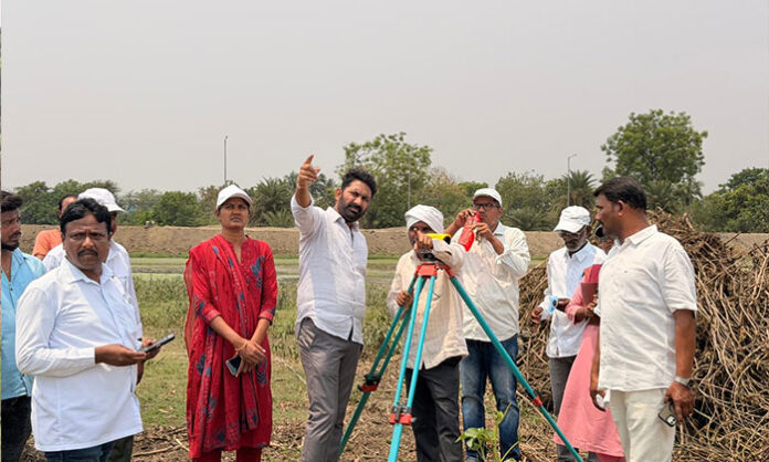 Officials inspecting Jathikunta tank development and encroachment survey work in Bellampalli