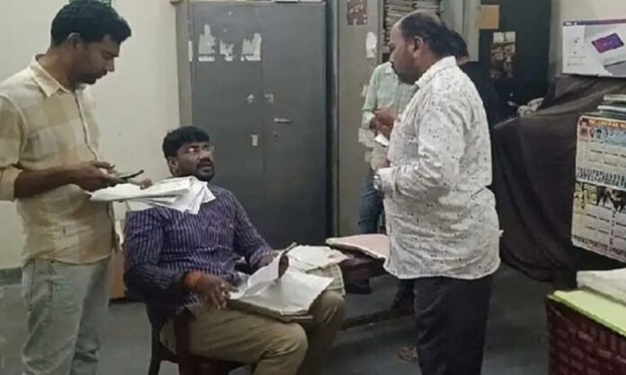 Vigilance officials conducting surprise raid and inspection at Karimnagar Sub Registrar office examining records and documents