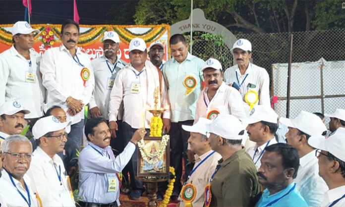 Athletes and workers celebrating 34th anniversary reunion at Pragati Stadium Srirampur with ceremonial lamp lighting