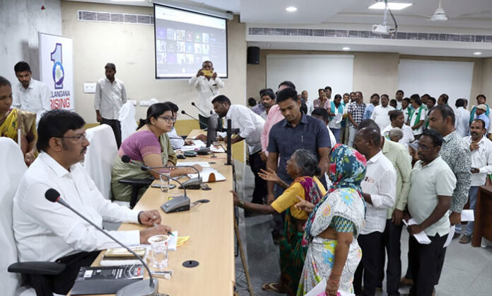District Collector Abhilasha Abhinav reviewing Prajavani public grievance applications and instructing officials for immediate resolution in Telangana