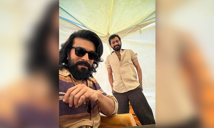 Ram Charan in rugged look on Peddi movie set with director Buchi Babu Sana during shoot update