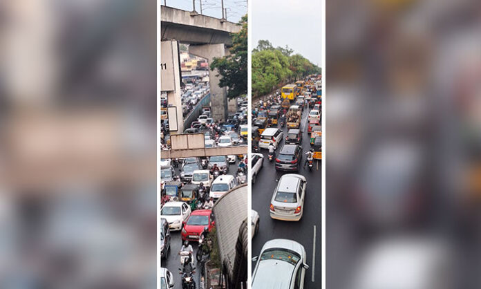 Heavy traffic congestion at Tarnaka flyover in Hyderabad due to rain causing long delays for commuters.