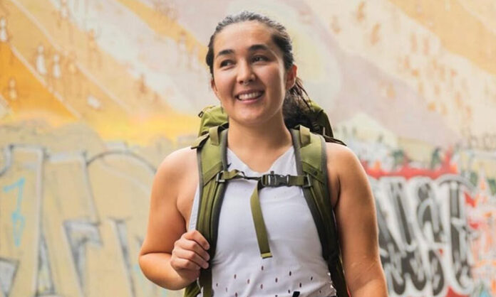 Afghan woman River Ahmed standing at Mount Everest summit after completing a historic climb to highlight women’s rights and freedom issues in Afghanistan.