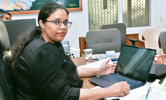 District Collector Khushboo Gupta registering her personal details online for Census 2027 self-enumeration using a laptop.