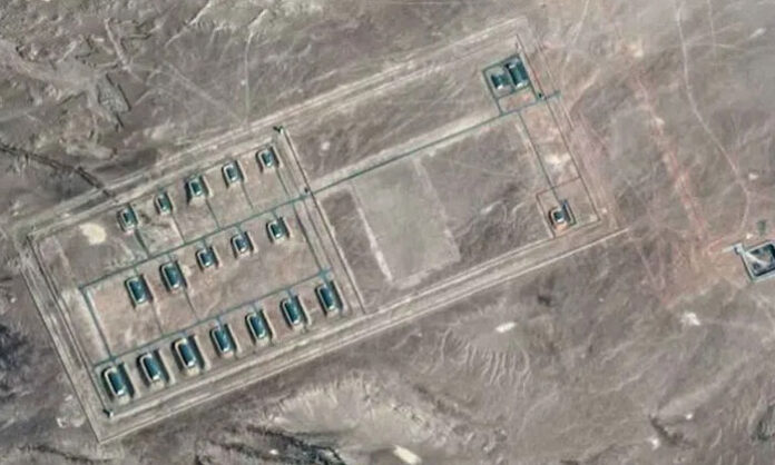 Satellite images showing large-scale construction activity at a Chinese military complex in Xinjiang, including missile launch pads and defense infrastructure.